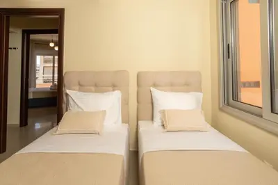 two beds sitting next to each other in a room at Zen City Beach Apartment in Chania Town