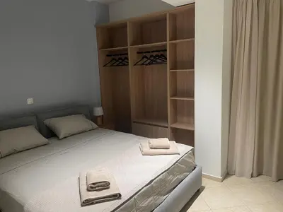 a bedroom with a bed with two towels on it at Nea Chora seaside suites in Chania Town