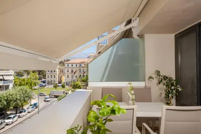 a balcony with a table and a view of a street at Kira Elegant City Nest in Chania Town