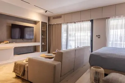 a living room with a bed and a dining room at Kira Elegant City Nest in Chania Town