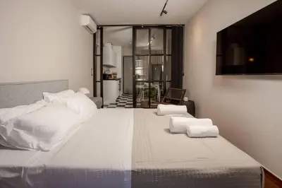 a bedroom with a large bed with white pillows at Demmi Central 2BR Designer Apt in Chania Town
