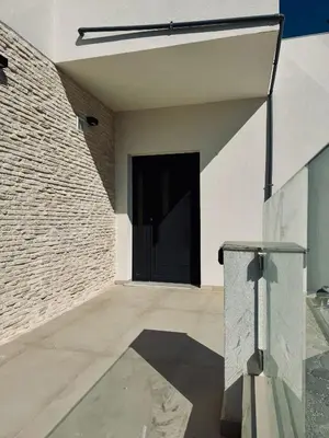 a door of a house with a brick wall at Villa & Apartament Armonia 4 Gaia Vita Gavalochori-Vamos KRETA in Vamos