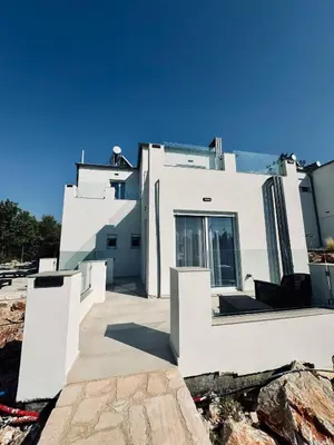 a white house with white walls and windows at Villa & Apartament Armonia 4 Gaia Vita Gavalochori-Vamos KRETA in Vamos