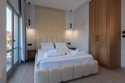 a bedroom with a large white bed with two pillows at Edward Luxury Suites in Chania Town