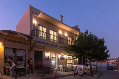 a building with people sitting outside of it at Edward Luxury Suites in Chania Town