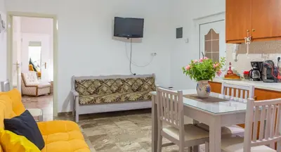 a living room with a table and a couch at Depi's Home in Kissamos