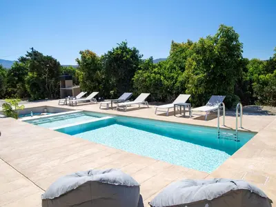 a swimming pool with lounge chairs and a swimming pool at PanStel - Villa Solene with private pool in Ayiá