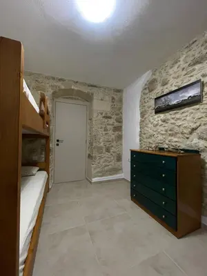 a bedroom with a bunk bed and a dresser at Casa Maria in Gramvousá