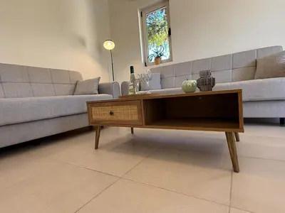 a living room with a couch and a coffee table at Villa Karneios in Tavronitis