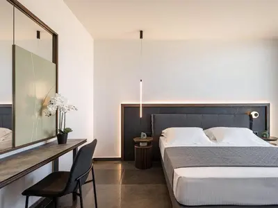 a bedroom with a large bed and a desk with a chair at Villa Thealon I New luxury villa with sea view and private infinity pool in Kissamos