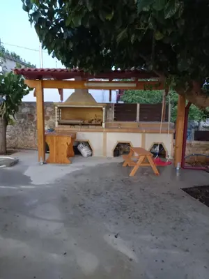 a picnic shelter with a stove and a table at Villa Makyva in Kámboi