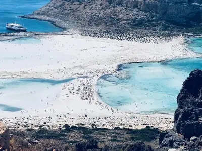 an aerial view of a beach with a group of people at Casa Aptera in Megála Khoráfia