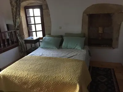 a bedroom with a bed in a room with a window at Casa Aptera in Megála Khoráfia
