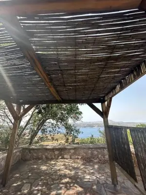 a view of the ocean from the inside of a building at Casa Aptera in Megála Khoráfia