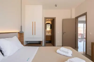 a bedroom with a bed with two towels on it at See2sea Cozy Apartments in Kolymvari