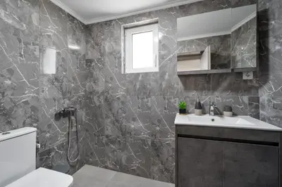 a bathroom with a sink and a toilet at Echoes of Prinos in Metókhion Yianítsari