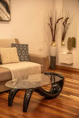 a living room with a couch and a glass coffee table at SUITEArT 1 Stylish apartment in Chania Town