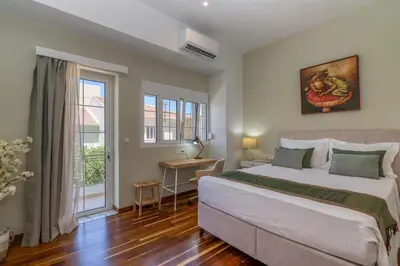a bedroom with a large bed and a window at SUITEArT 1 Stylish apartment in Chania Town