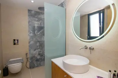 a bathroom with a sink and a mirror at Katakis Afroditi-Athina in Agios Onoufrios