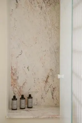 three candles sitting on a shelf in front of a wall at Evrima High End Residence in Chania Town