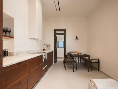 a kitchen with a table and a sink and a microwave at Evrima High End Residence in Chania Town