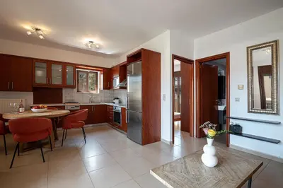 a kitchen with a table and a dining room at Light House Chania - 5 Min to Beach and Free Parking in Chania Town