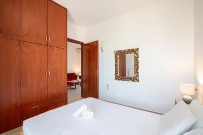 a bedroom with a bed and a dresser and a mirror at Light House Chania - 5 Min to Beach and Free Parking in Chania Town