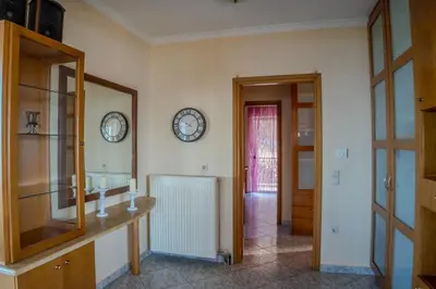 a bathroom with a mirror and a clock on the wall at Elysian Bayview Souda Bay Panorama Chania in Zakhariás