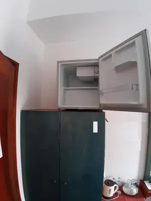 a refrigerator with a microwave on top of it at Castle Inn in Chania Town