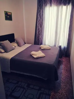 a bedroom with two beds with towels on them at Castle Inn in Chania Town