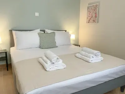 a bedroom with a bed with towels on it at CASA 7 urban 3 bedroom apartment in Chania Town