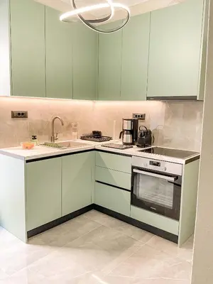 a kitchen with green cabinets and a sink at CASA 7 urban 3 bedroom apartment in Chania Town