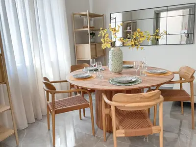 a dining room with a wooden table and chairs at CASA 7 urban 3 bedroom apartment in Chania Town