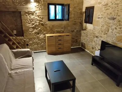 a living room with a couch and a table at Stone House Experience in Voúvai