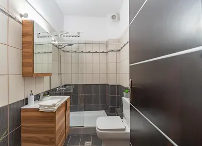 a bathroom with a sink and a toilet and a tub at Kalamaki del mar apartments in Galatás