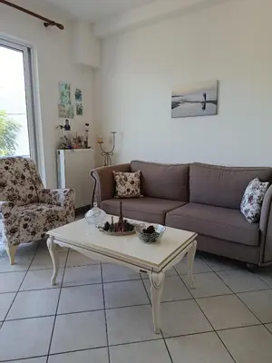 a living room with a couch and a coffee table at By the sea in Chania Town