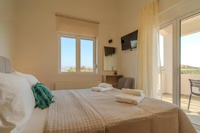 a bedroom with a bed with towels on it at Olea Retreat Villa in Yerakianá