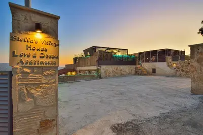 a building with a sign on top of it at Villa Ravdoucha in Ravdhoúkha