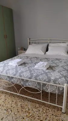 a bed with two white towels on top of it at Chania ELIA apARTment Chalepa in Chania Town