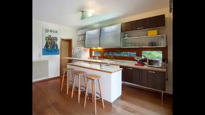 a kitchen with a counter and stools in it at Villa Orgoni in Plataniás