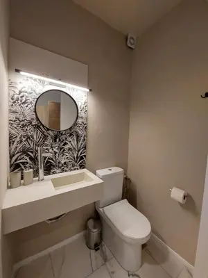 a bathroom with a toilet and a sink and a mirror at Chavalon Apartments in Kalyves
