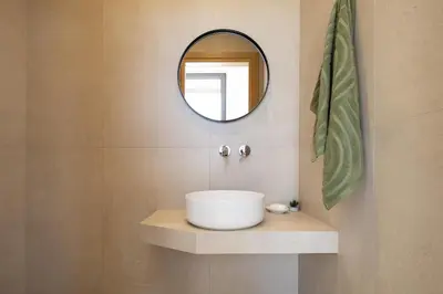 a bathroom with a sink and a mirror at Salisol Villa - Green Oasis in Chania Town