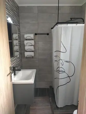 a bathroom with a shower curtain and a sink at A to Z in Palaiochóra