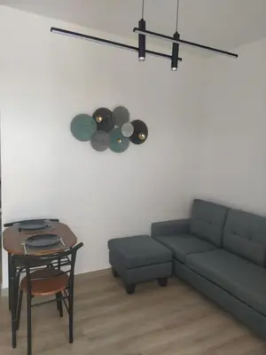 a living room with a couch and a table at A to Z in Palaiochóra