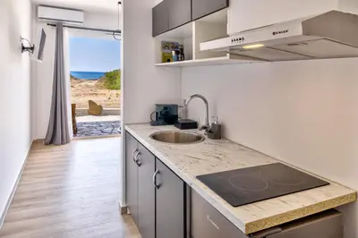 a kitchen with a sink and a view of the ocean at A to Z in Palaiochóra