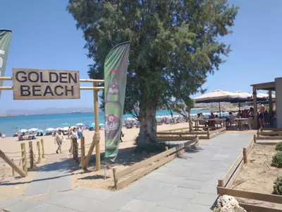 a beach with a sign that reads golden beach at Hillside Escape by the Sea in Daratso