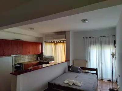 a bedroom with a bed with two white towels on it at Nikolaos central cozy apartment & free parking in Chania Town