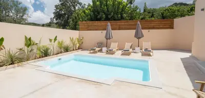 a pool in a backyard with chairs and a swimming pool at Roots Villa in Skinés