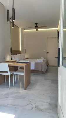 a bedroom with a bed and a table and chairs at Dabia Escape in Chania Old Town in Chania Town