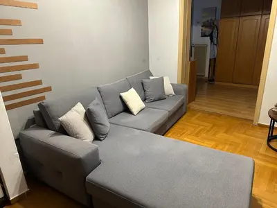 a living room with a gray couch with pillows at Chania City Center Apartment with Balcony Central Aircon in Chania Town